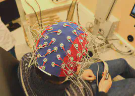 We measure the electrical activity of the brain via an electroencephalogram (EEG).